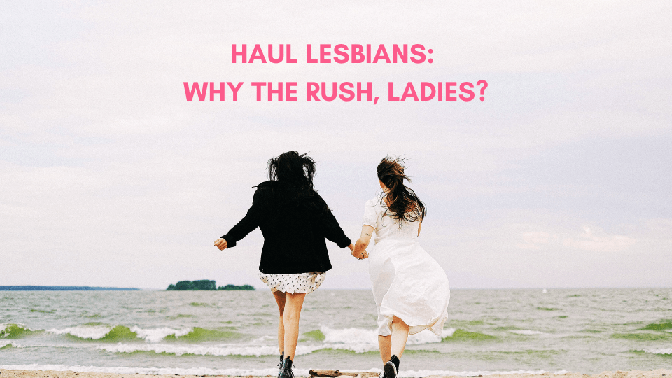 Two women holding hands and running along the beach, with the caption 'Haul Lesbians: Why the Rush, Ladies?' in bold pink letters above them